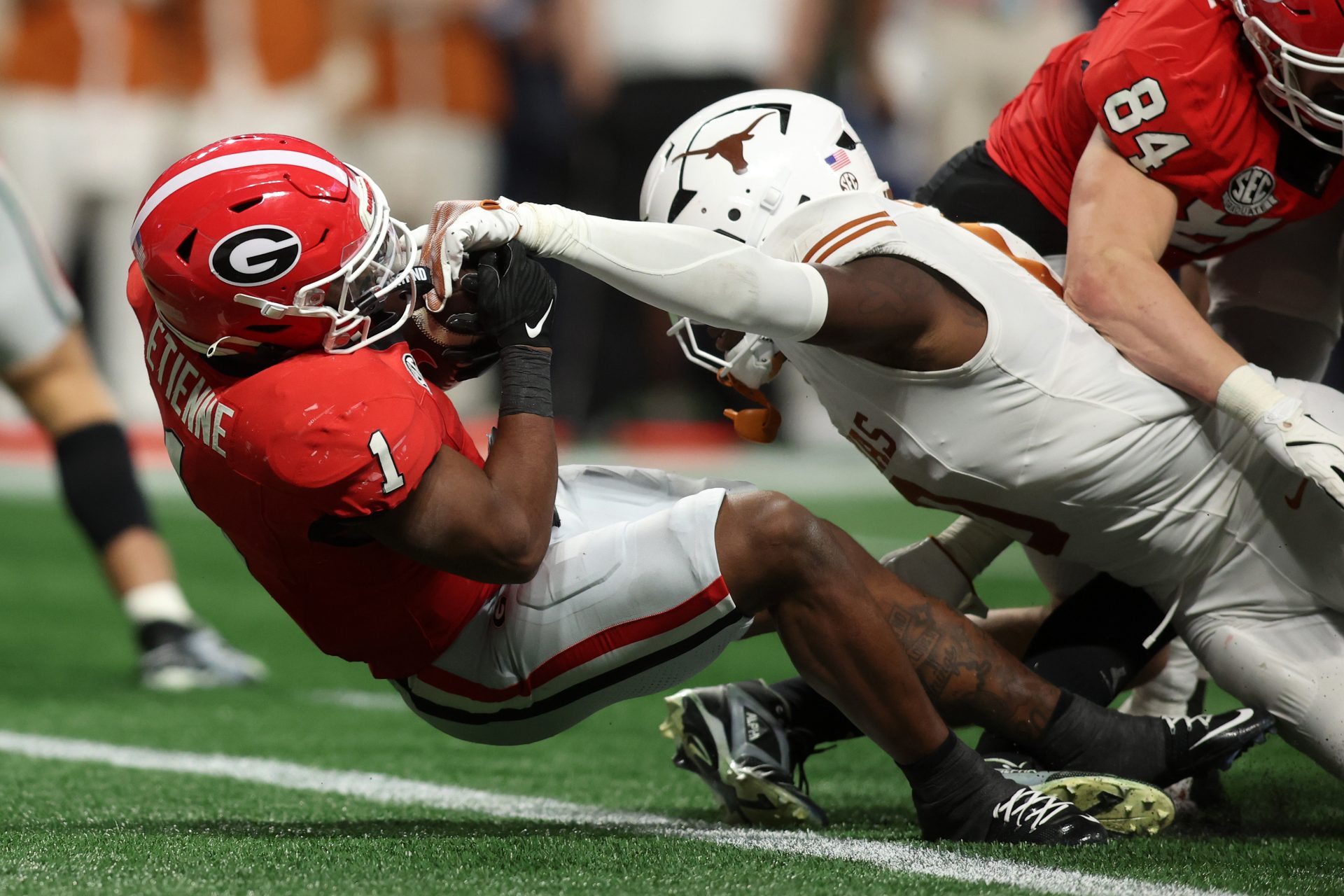 Georgia Bulldogs running back Trevor Etienne (1) rushes for a touchdown in overtime to defeat the Texas Longhorns in the 2024 SEC Championship game at Mercedes-Benz Stadium.