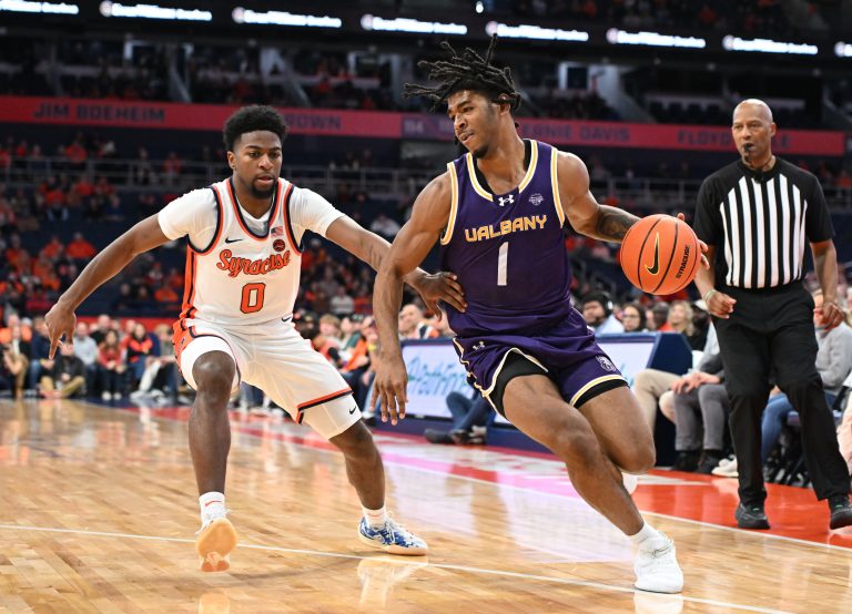 Albany Great Danes guard Amar'e Marshall (1) drives the ball past Syracuse Orange guard Kyle Cuffe Jr. (0) in the first half at the JMA Wireless Dome.