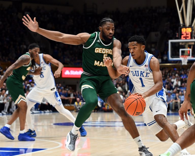 Duke Blue Devils guard Caleb Foster (1) drives to the basket as George Mason Patriots forward Giovanni Emejuru (5) defends during the first half at Cameron Indoor Stadium.