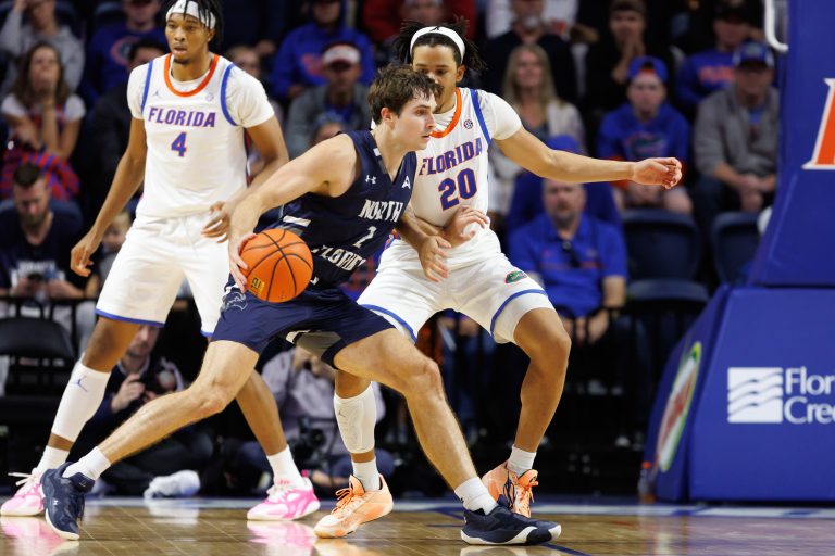 North Florida Ospreys forward Liam Murphy (7) posts up against Florida Gators guard Isaiah Brown (20) during the second half at Exactech Arena at the Stephen C. O'Connell Center.