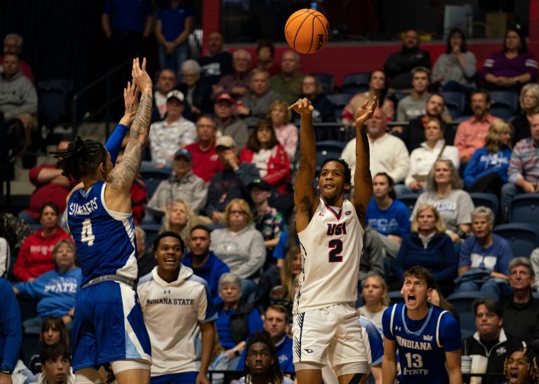 Southern Indiana's Jayland Randall (2) takes a three-point shot as the University of Southern Indiana Screaming Eagles play the Indiana State Sycamores at Liberty Arena in Evansville, Ind., Monday, Nov. 25, 2024.