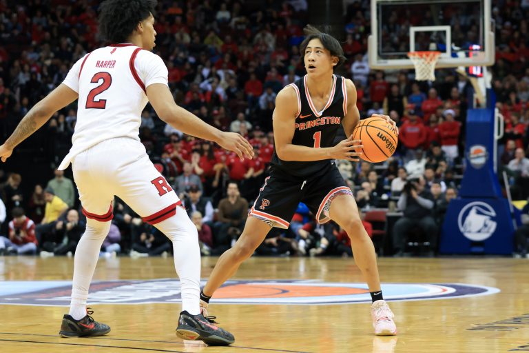 Princeton Tigers guard Xaivian Lee (1) looks to pass while being defended by Rutgers Scarlet Knights guard Dylan Harper (2) during the second half at Prudential Center.