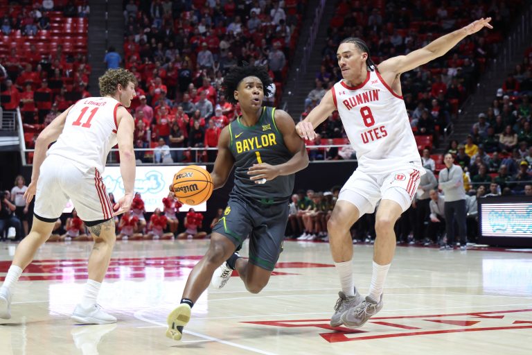 Baylor Bears guard Robert Wright III (1) drives to the basket against Utah Utes forward Keanu Dawes (8) during the first half at Jon M. Huntsman Center.