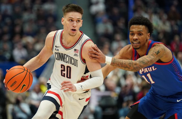 UConn Huskies guard Aidan Mahaney (20) drives the ball against DePaul Blue Demons guard CJ Gunn (11) in the first half at XL Center.
