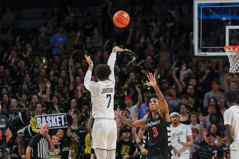 UCF Knights guard Dior Johnson (7) shoots over Cincinnati Bearcats guard Rayvon Griffith (3) during the first half at Addition Financial Arena.