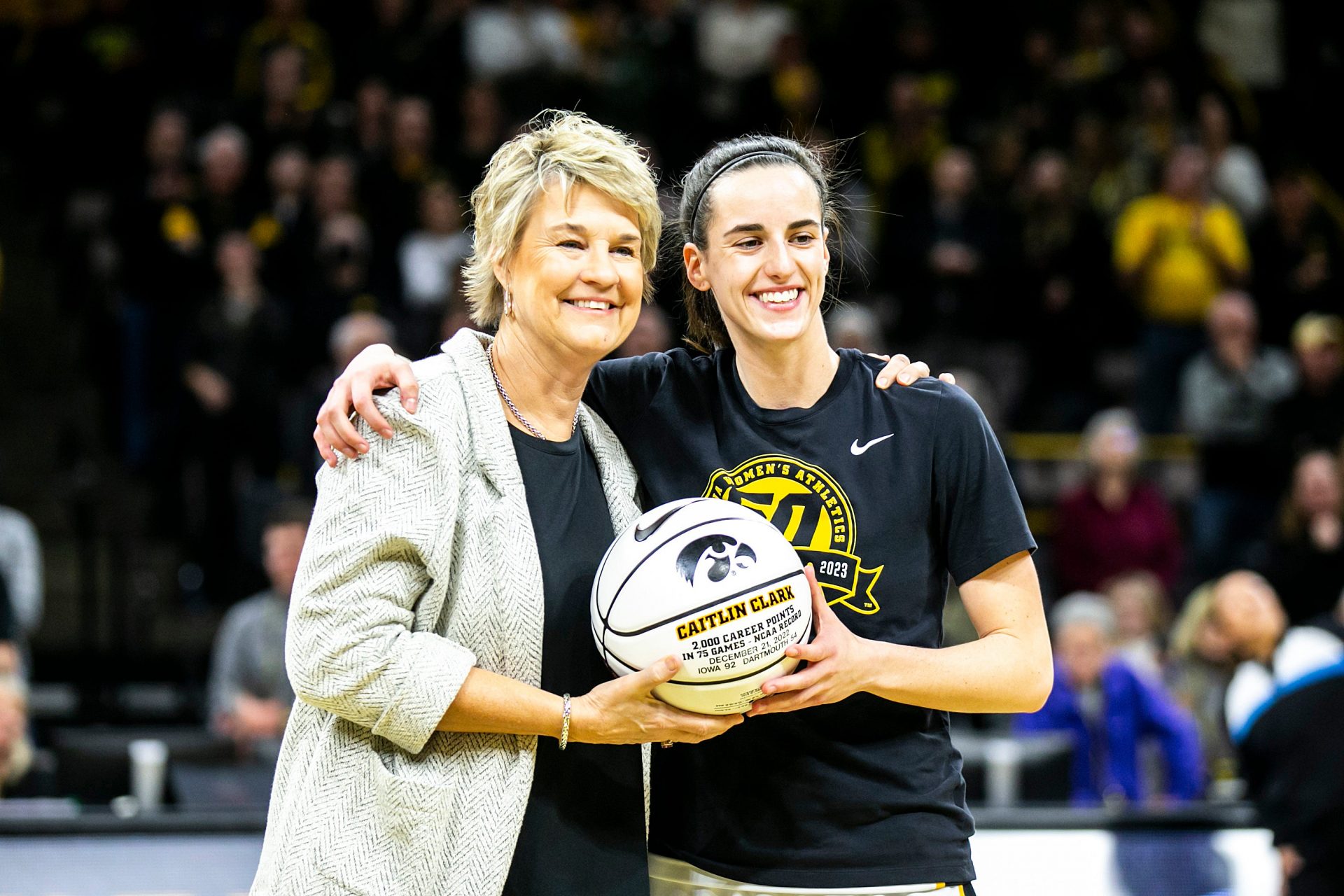 Iowa head coach Lisa Bluder, left, poses for a photo with Iowa guard Caitlin Clark (22) before a NCAA Big Ten Conference women's basketball game against Purdue, Thursday, Dec. 29, 2022