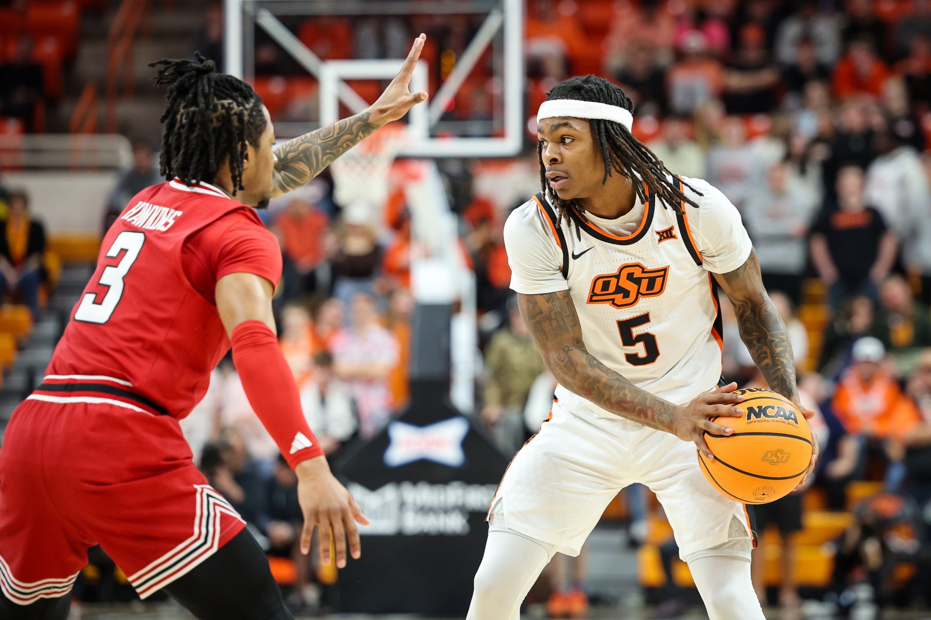 Oklahoma State Cowboys guard Khalil Brantley (5) sets the play around Texas Tech Red Raiders guard Elijah Hawkins (3) during the first half at Gallagher-Iba Arena.