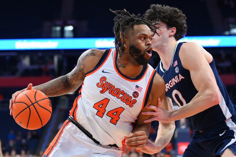 Syracuse Orange center Eddie Lampkin Jr. (44) drives against Virginia Cavaliers forward Blake Buchanan (0) during the first half at the JMA Wireless Dome.