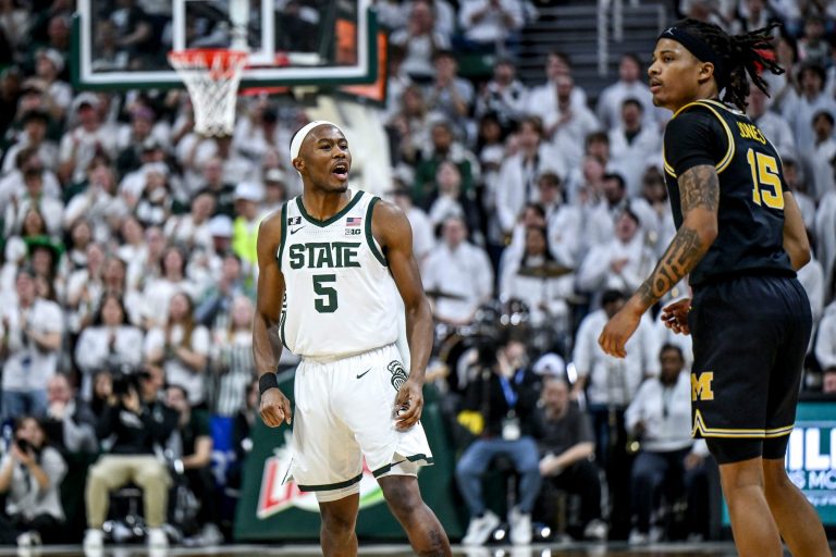 Michigan State's Tre Holloman, left, jaws at Michigan's Rubin Jones after scoring during the second half on Sunday, March 9, 2025, at the Breslin Center in East Lansing.