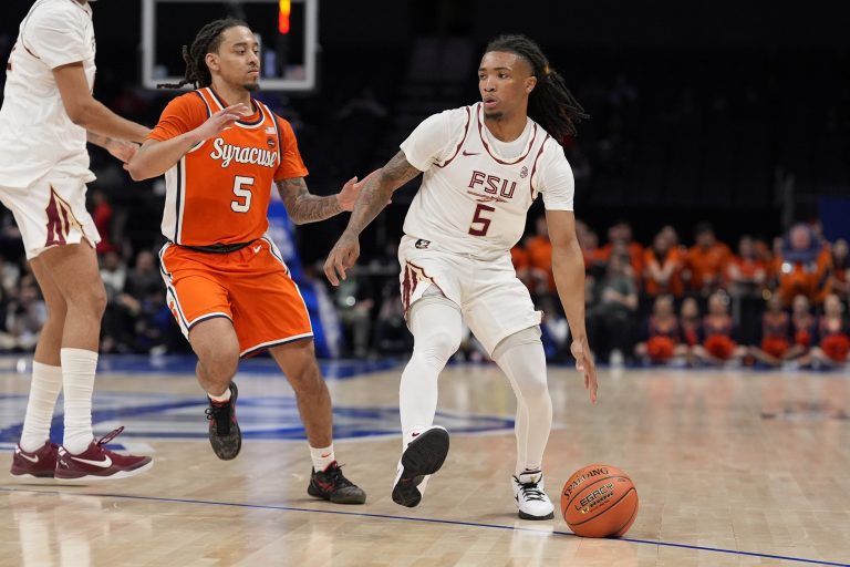 Florida State Seminoles guard Daquan Davis (5) handles the ball defended by Syracuse Orange guard Jaquan Carlos (5) during the second half at Spectrum Center.
