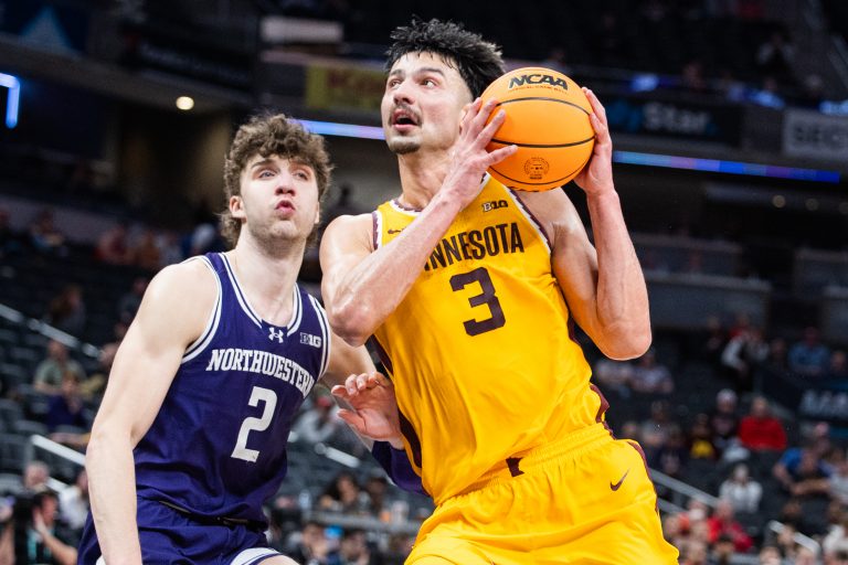 Minnesota Golden Gophers forward Dawson Garcia (3) shoots the ball while Northwestern Wildcats forward Nick Martinelli (2) defends in the second half at Gainbridge Fieldhouse.