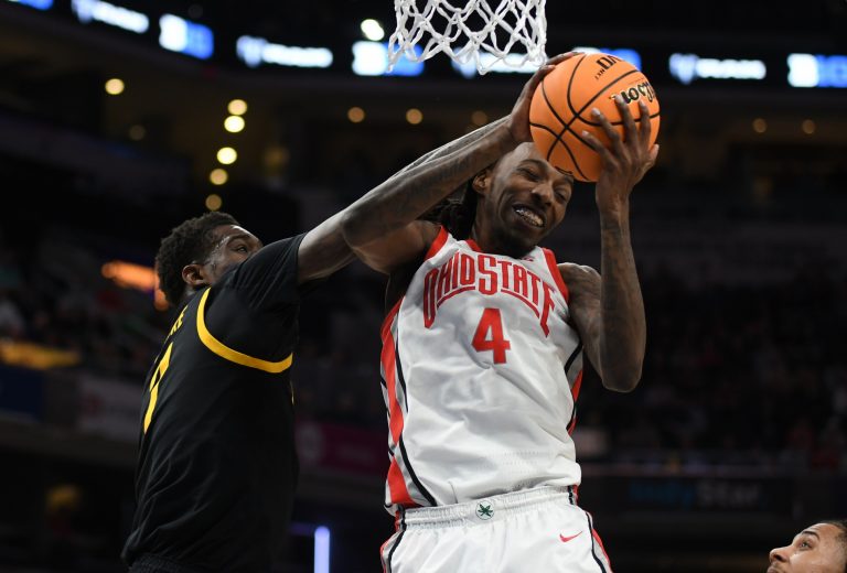 Ohio State Buckeyes forward Aaron Bradshaw (4) rebounds the ball against Iowa Hawkeyes forward Seydou Traore (7) during the second half at Gainbridge Fieldhouse.