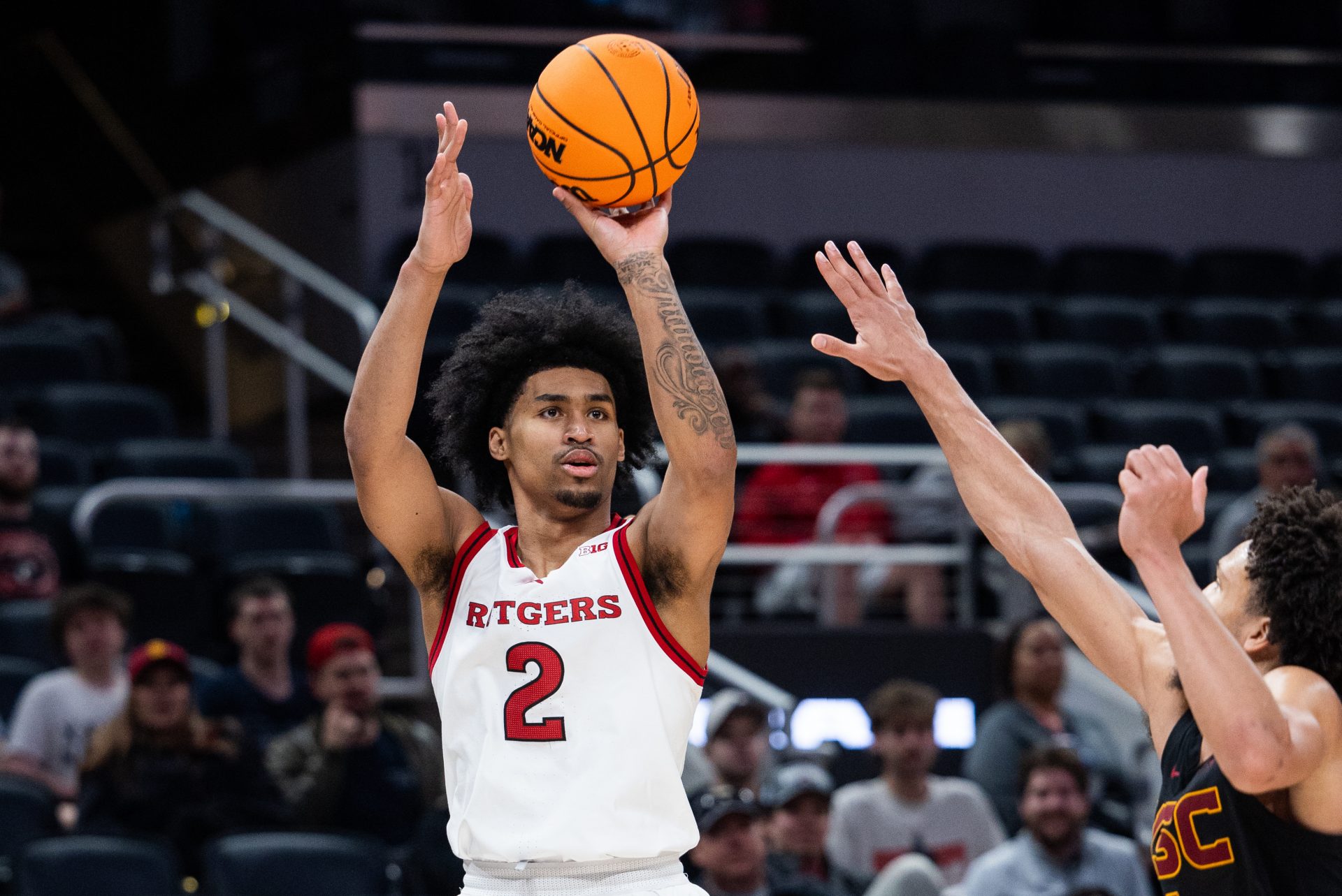 Rutgers Scarlet Knights guard Dylan Harper (2) shoots the ball while USC Trojans guard Desmond Claude (1) defends in the second half at Gainbridge Fieldhouse.