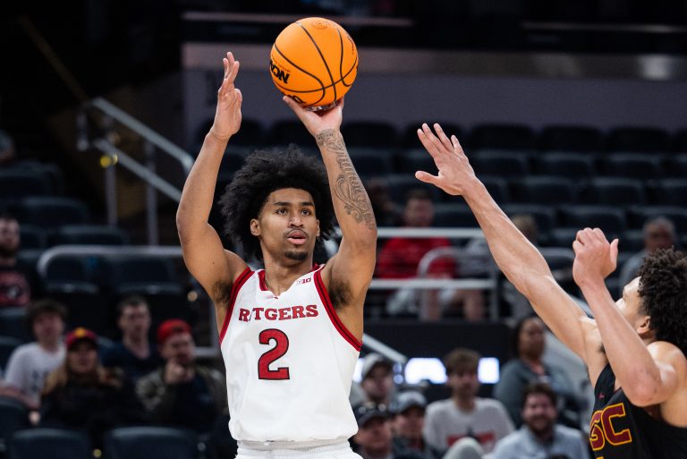 Rutgers Scarlet Knights guard Dylan Harper (2) shoots the ball while USC Trojans guard Desmond Claude (1) defends in the second half at Gainbridge Fieldhouse.