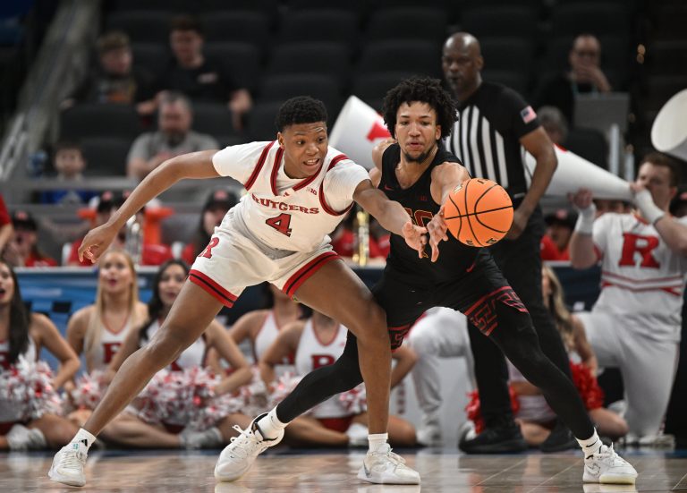 USC Trojans guard Desmond Claude (1) knocks the ball away from Rutgers Scarlet Knights guard Ace Bailey (4) during the second half at Gainbridge Fieldhouse.