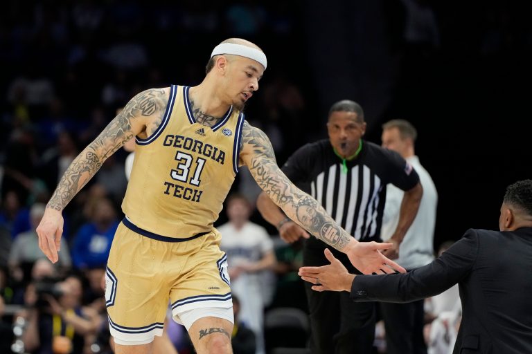 Georgia Tech Yellow Jackets forward Duncan Powell (31) reacts with head coach Damon Stoudamire after scoring in the first half at Spectrum Center.
