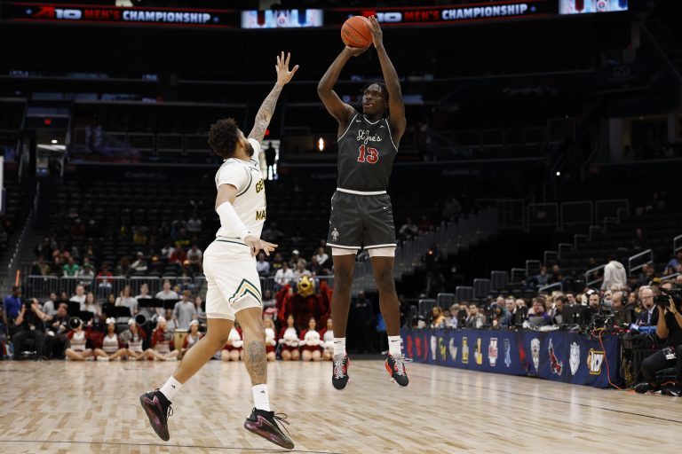 Saint Joseph's Hawks forward Rasheer Fleming (13) shoots the ball over Saint Joseph's Hawks forward Shawn Simmons II (10) in the first half at Capital One Arena.