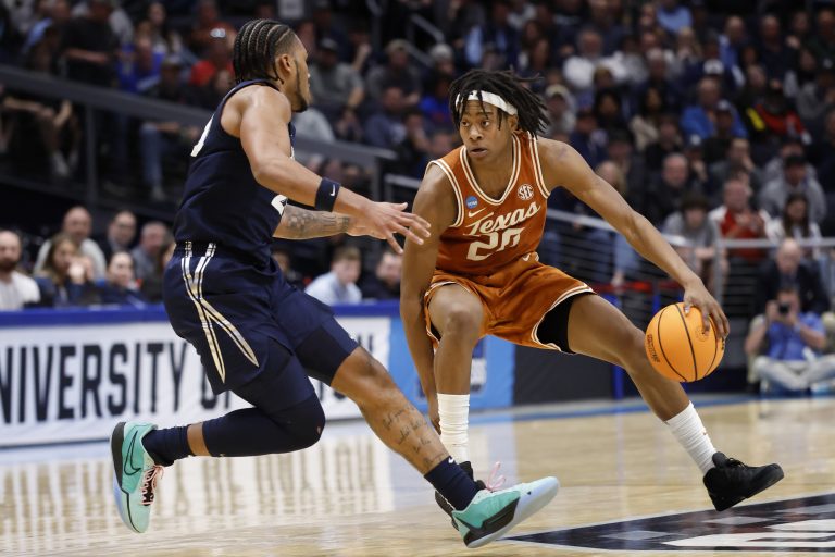 Texas Longhorns forward Devon Pryor (22) plays the ball defended by Xavier Musketeers guard Dayvion McKnight (20) in the first half at UD Arena.