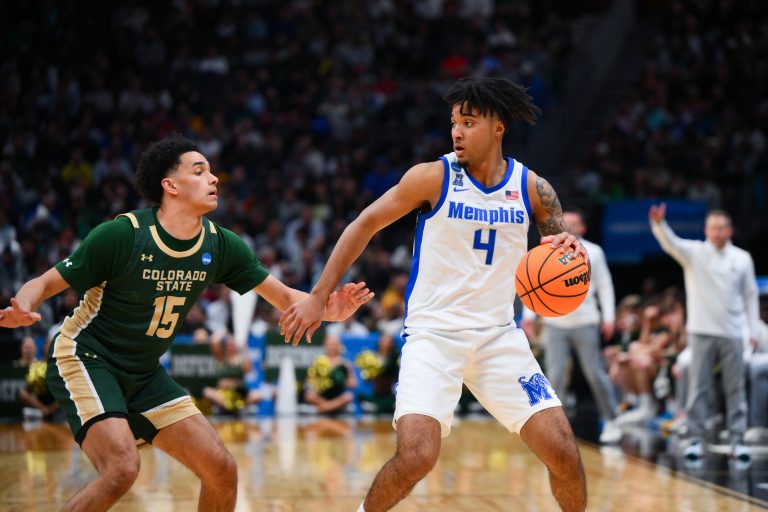 Memphis Tigers guard PJ Haggerty (4) looks for an open teammate while being defended by Colorado State Rams guard Jalen Lake (15) during the second half at Climate Pledge Arena.