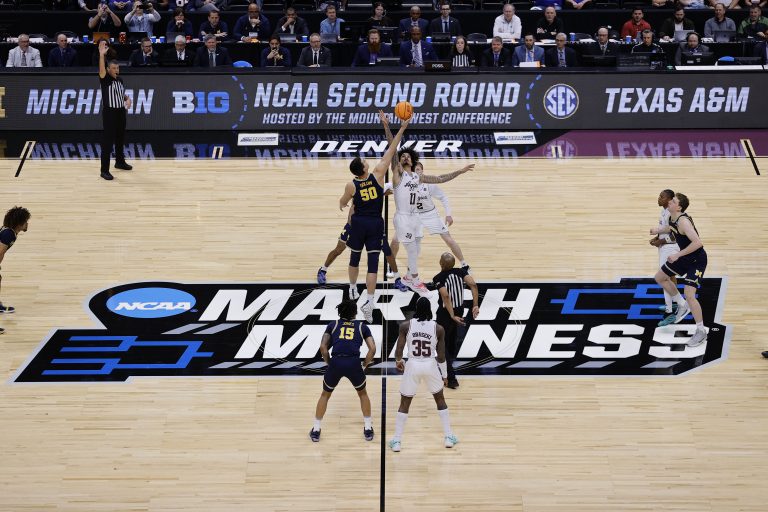 Michigan Wolverines center Vladislav Goldin (50) and Texas A&M Aggies forward Andersson Garcia (11) attempt to get the opening tip off during the first half in the second round of the NCAA Tournament at Ball Arena.