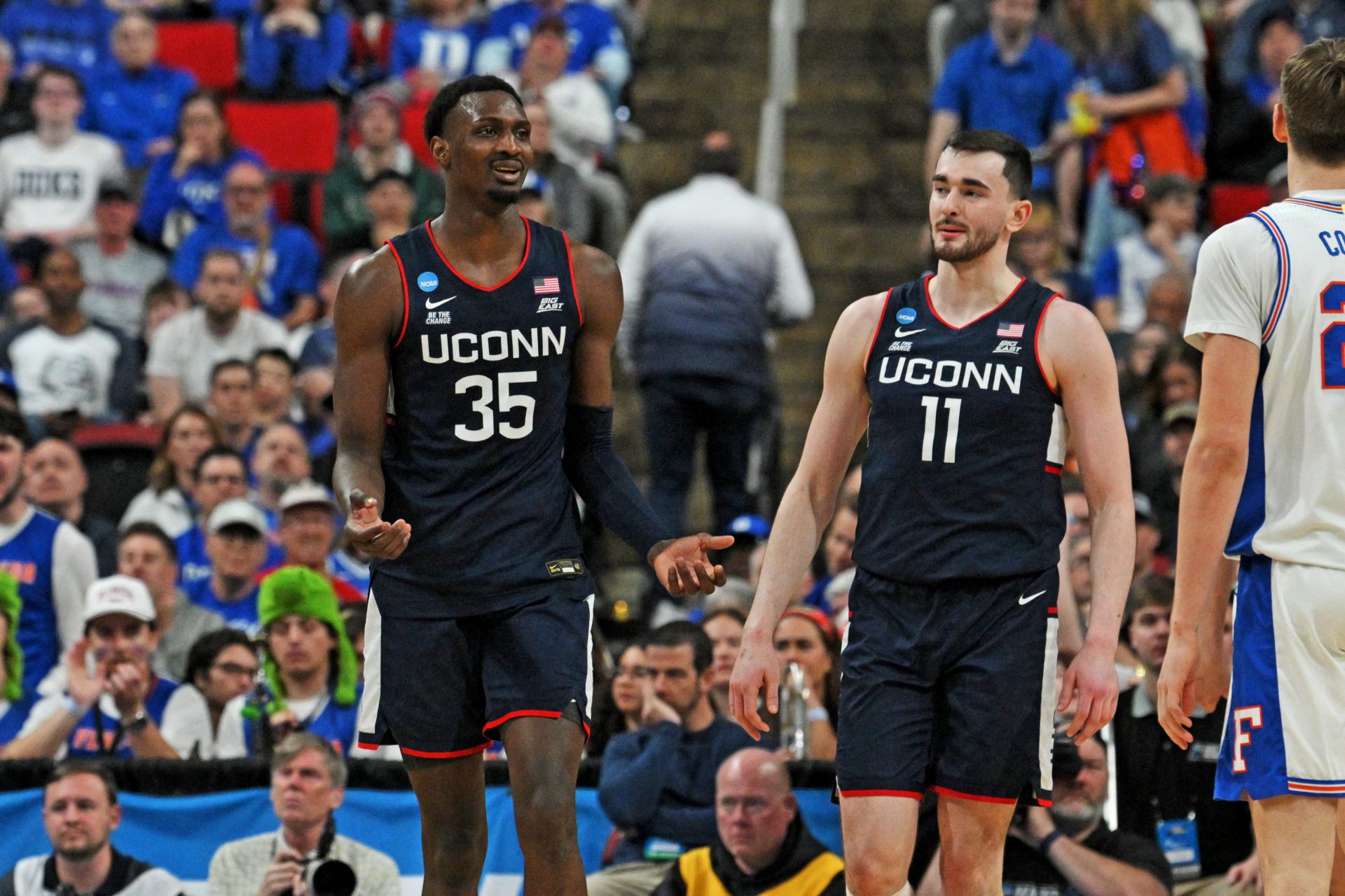 Connecticut Huskies center Samson Johnson (35) and Connecticut Huskies forward Alex Karaban (11) react after a play during the second half against the Florida Gators in the second round of the NCAA Tournament at Lenovo Center.