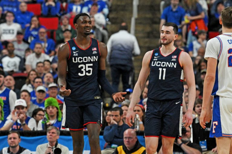 Connecticut Huskies center Samson Johnson (35) and Connecticut Huskies forward Alex Karaban (11) react after a play during the second half against the Florida Gators in the second round of the NCAA Tournament at Lenovo Center.