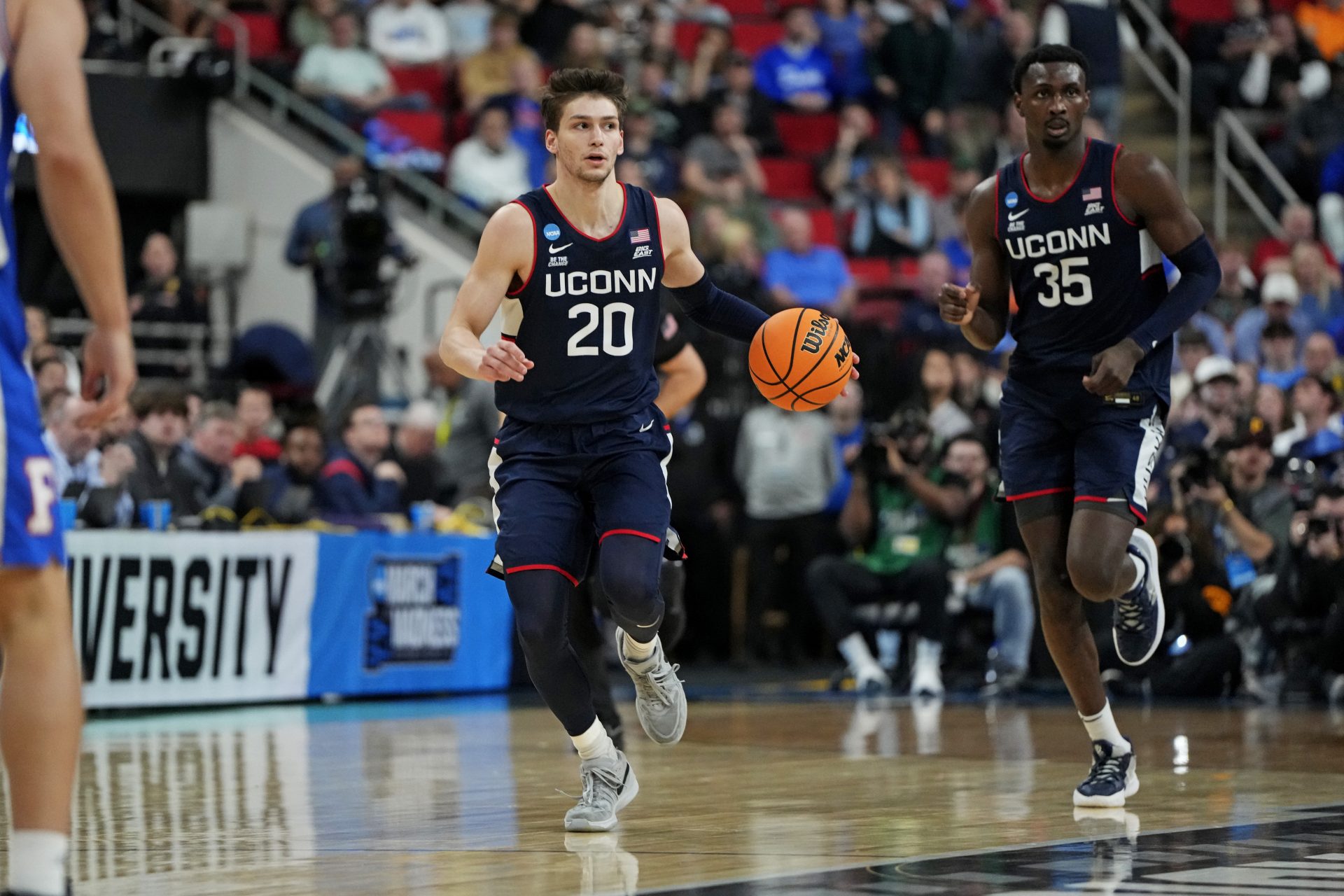 Connecticut Huskies guard Aidan Mahaney (20) controls the ball during the second half against the Florida Gators in the second round of the NCAA Tournament at Lenovo Center.
