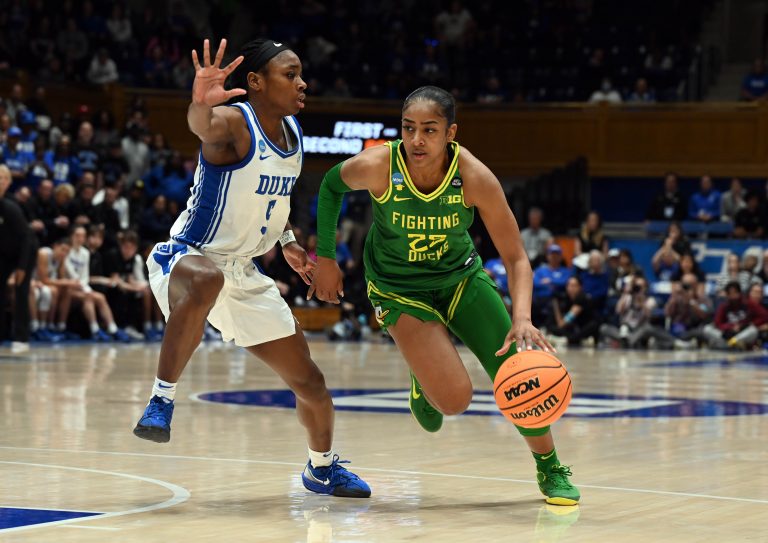 Oregon Ducks guard Deja Kelly (25) drives to the basket as Duke Blue Devils guard Oluchi Okananwa (5) defends during the second half at Cameron Indoor Stadium. The Blue Devils won 59-53.