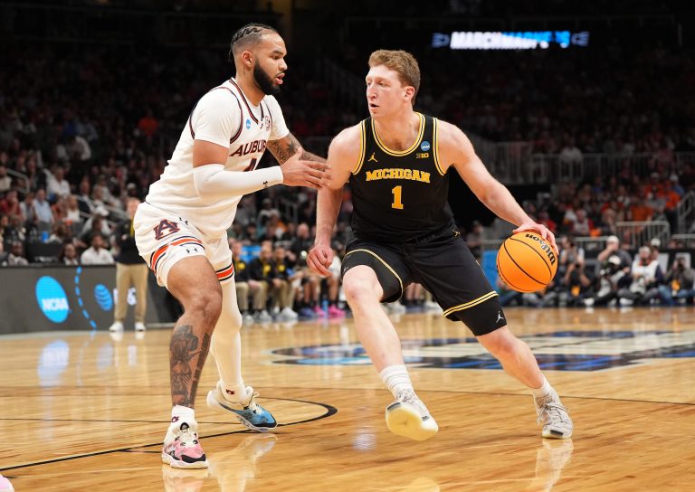 Michigan Wolverines center Danny Wolf (1) drives against Auburn Tigers forward Johni Broome (4) in the first half of a South Regional semifinal of the 2025 NCAA tournament at State Farm Arena.
