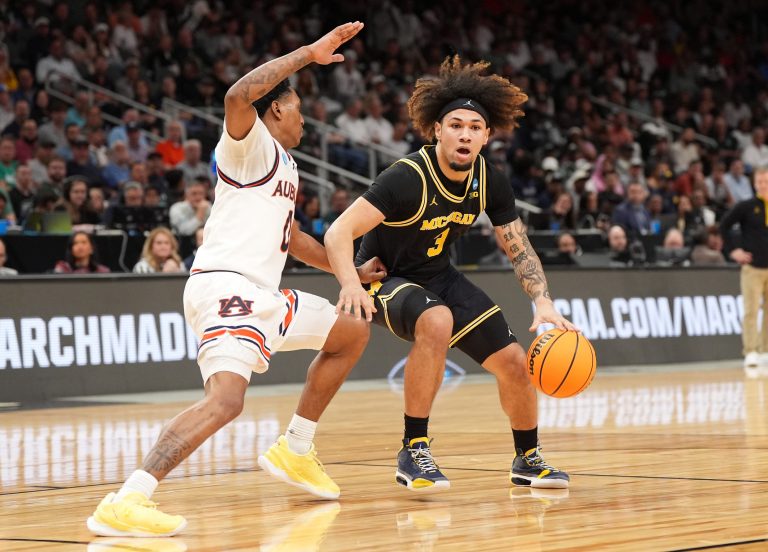 Michigan Wolverines guard Tre Donaldson (3) dribbles against Auburn Tigers guard Tahaad Pettiford (0) in the first half of a South Regional semifinal of the 2025 NCAA tournament at State Farm Arena.