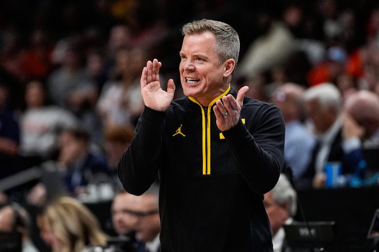 Michigan head coach Dusty May cheers on after a play against Auburn during the second half of the Sweet 16 round of NCAA tournament at State Farm Arena