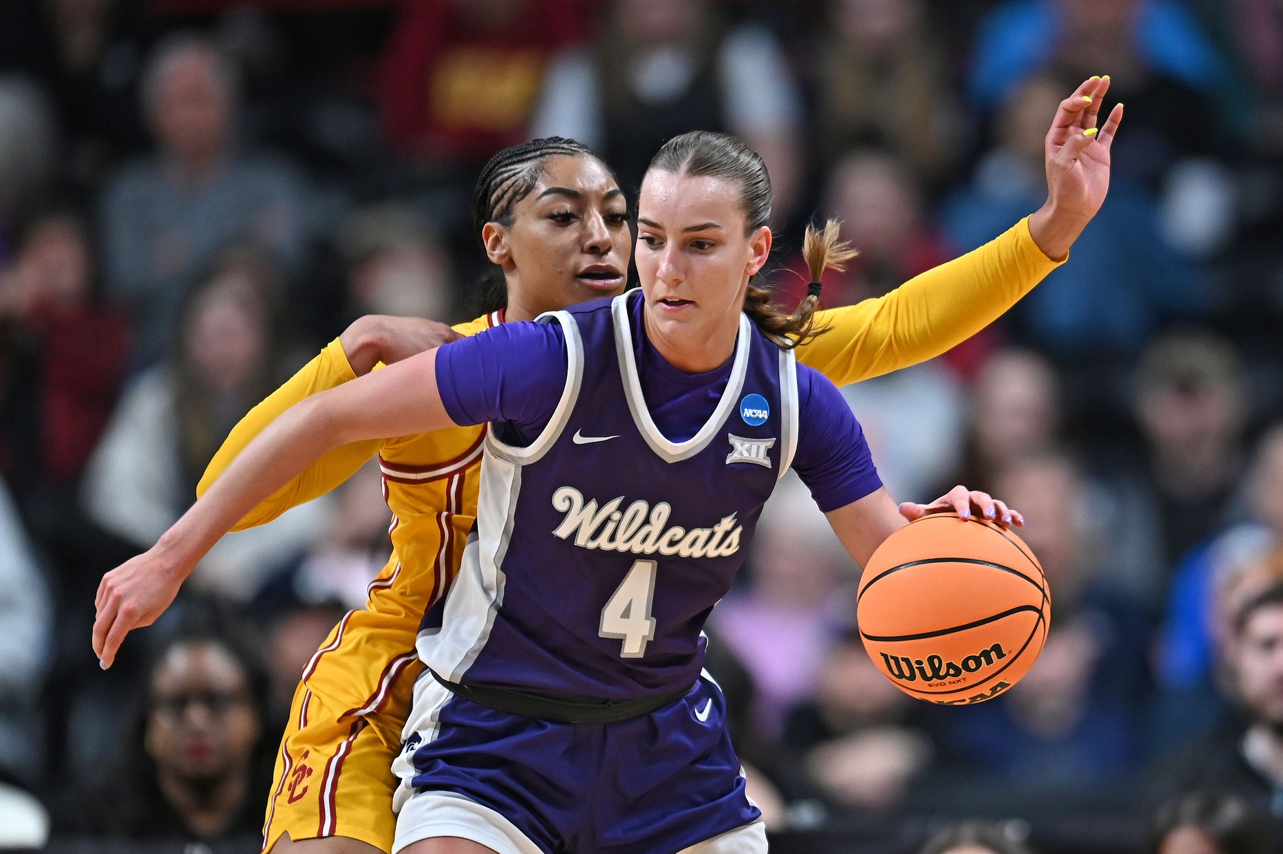 Kansas State Wildcats guard Serena Sundell (4) controls the ball against USC Trojans guard Kennedy Smith (11) during the first half of a Sweet 16 NCAA Tournament basketball game at Spokane Arena. at Spokane Arena.