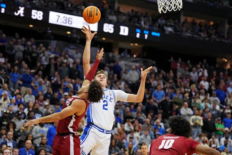Duke Blue Devils forward Cooper Flagg (2) shoots the ball against Alabama Crimson Tide guard Mark Sears (1) during the second half in the East Regional final of the 2025 NCAA tournament at Prudential Center.