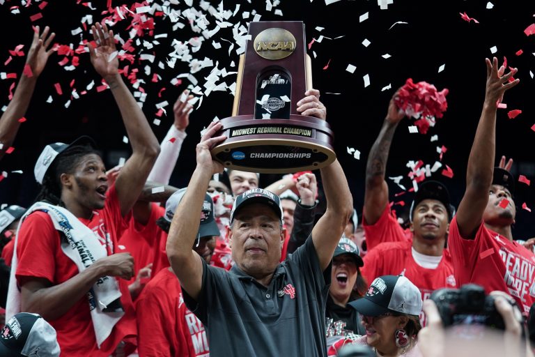 Houston Cougars head coach Kelvin Sampson holds the trophy for winning the Midwest Regional final of the 2025 NCAA tournament at Lucas Oil Stadium.