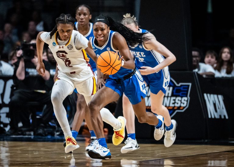Duke Blue Devils guard Oluchi Okananwa (5) dribbles the ball down the court, pursued by South Carolina Gamecocks guard MiLaysia Fulwiley (12) in the second half of the NCAA Regional Final game at Legacy Arena in Birmingham Alabama, March 30, 2025.