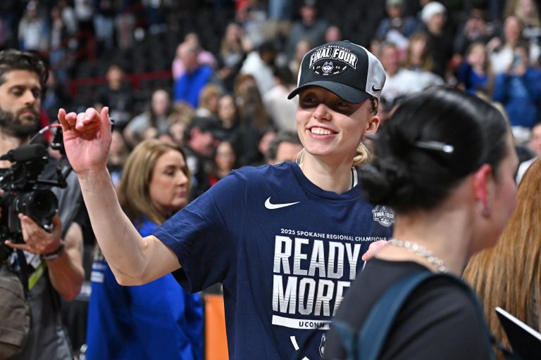 UConn Huskies guard Paige Bueckers (5) waves to the crowd after a Elite 8 NCAA Tournament basketball game against the USC Trojans at Spokane Arena.