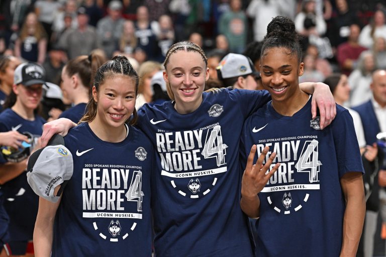 UConn Huskies guard Kaitlyn Chen (20), guard Paige Bueckers (5) and forward Aubrey Griffin (44) pose for a photo after a Elite 8 NCAA Tournament basketball game against the USC Trojans at Spokane Arena.