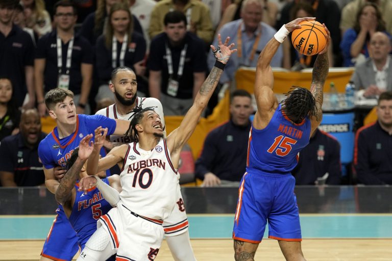 Florida Gators guard Alijah Martin (15) grabs a rebound against Auburn Tigers guard Chad Baker-Mazara (10) during the second half in the semifinals of the men's Final Four of the 2025 NCAA Tournament at Alamodome.