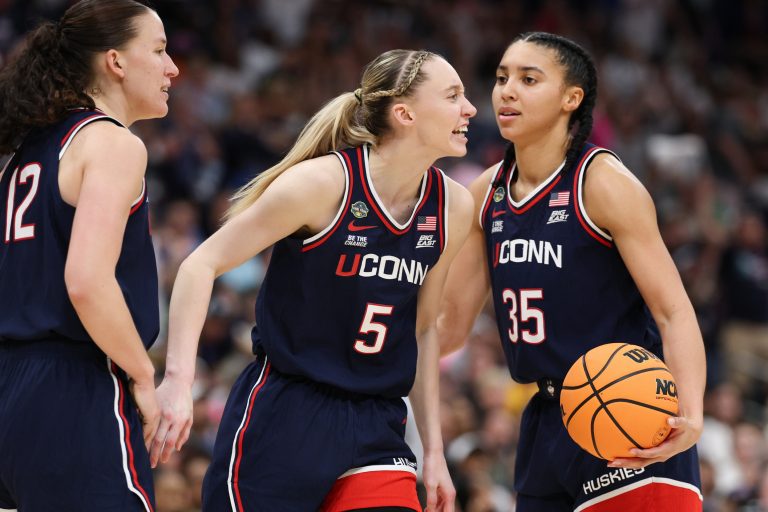 Connecticut Huskies guard Paige Bueckers (5) reacts with teammates guard Ashlynn Shade (12) and guard Azzi Fudd (35) during the second half against the South Carolina Gamecocks of the national championship of the women's 2025 NCAA tournament at Amalie Arena.