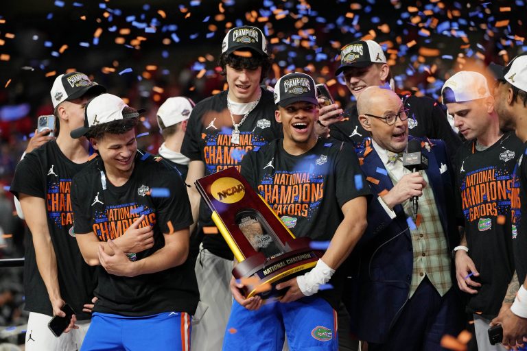 Florida Gators center Rueben Chinyelu (9) holds the trophy after winning the national championship game of the Final Four of the 2025 NCAA Tournament at the Alamodome.