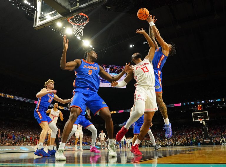 Houston Cougars forward J'Wan Roberts (13) battles for a rebound between Florida Gators guard Alijah Martin (15) and Florida Gators center Rueben Chinyelu (9) in the second half in the national championship game.