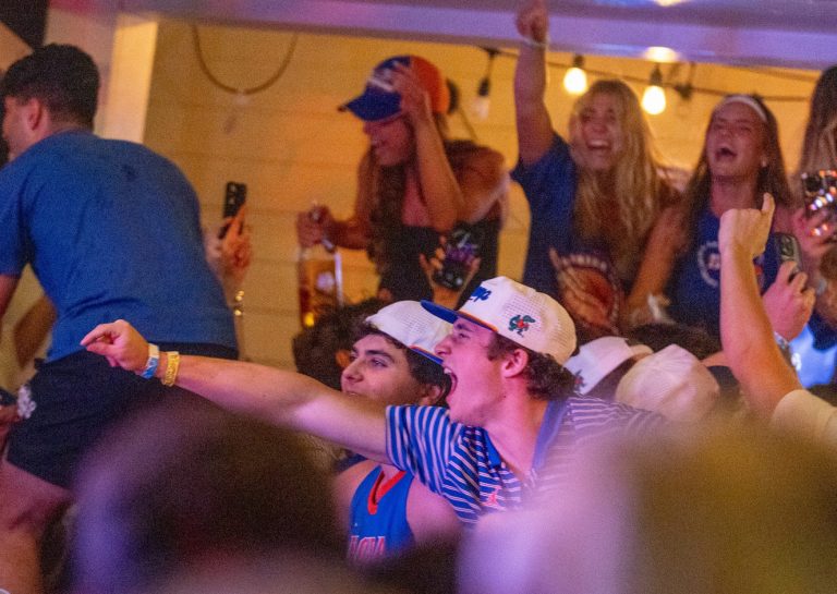 Fans at The Swamp Restaurant in Gainesville erupt in celebration Monday night after the Florida Gators beat the Houston Cougars for the NCAA championship.