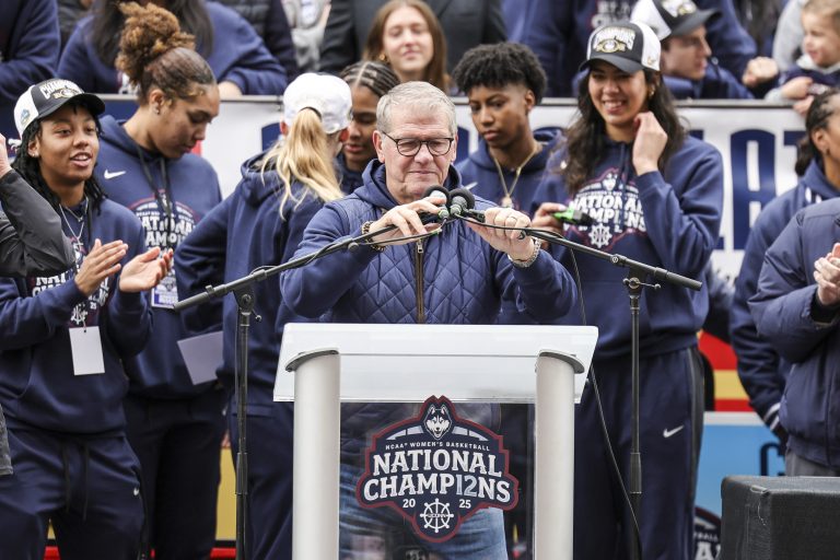 UConn Huskies head coach Geno Auriemma adjusts the microphones prior to his speech during the Final Four champions victory parade and rally outside of the XL Center in Hartford, CT.