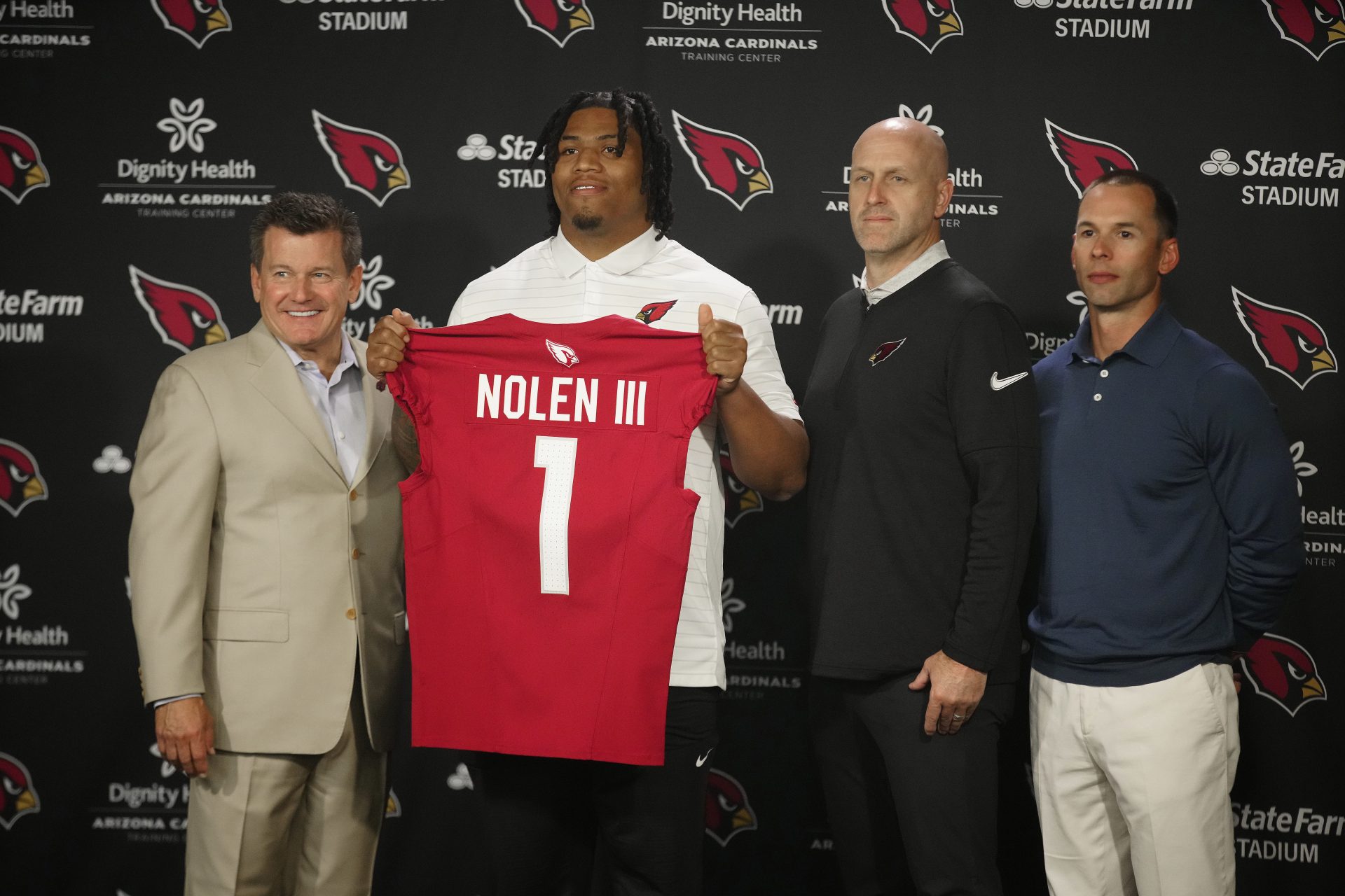Cardinals defensive lineman Walter Nolen stands and holds his jersey with owner Michael Bidwill (left to right), general manager Monti Ossenfort and head coach Jonathan Gannon during his introductory news conference inside the Arizona Cardinals training facility on April 25, 2025, in Tempe.