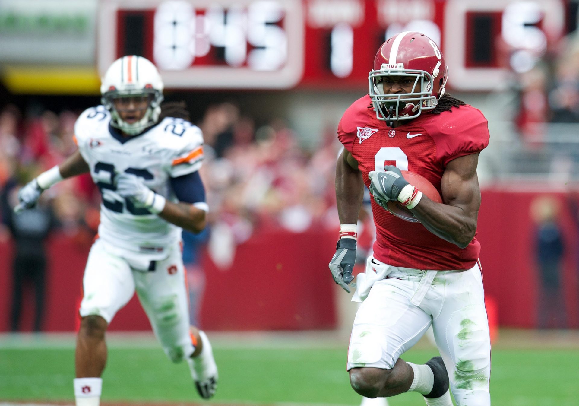 Alabama Crimson Tide wide receiver Julio Jones (8) runs for a touchdown after catching a pass from quarterback Greg McElroy (not pictured) against the Auburn Tigers in the first quarter at Bryant-Denny Stadium.