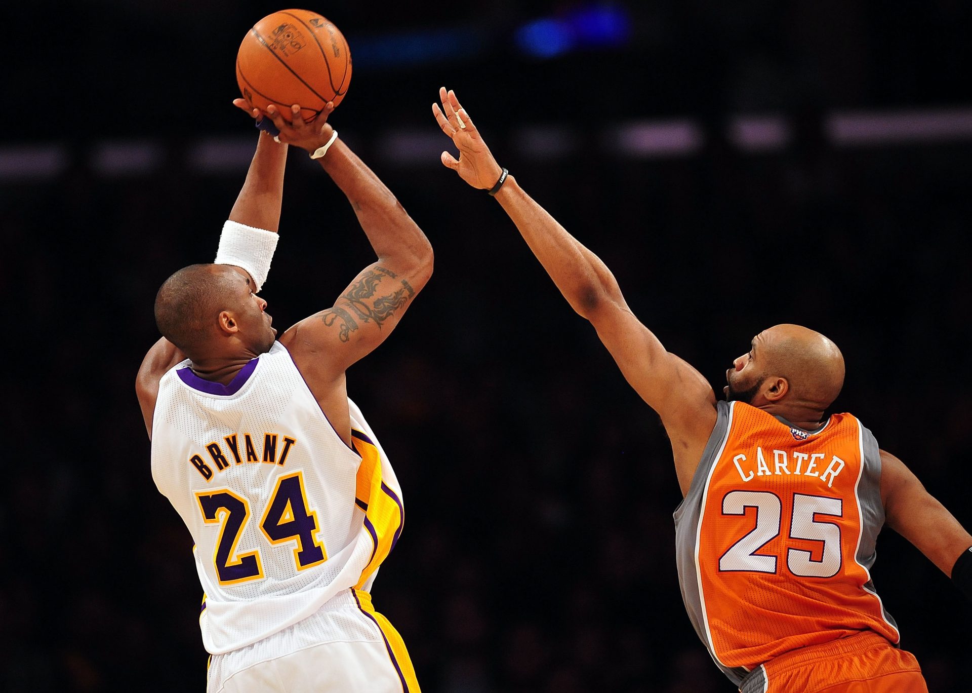 Los Angeles Lakers shooting guard Kobe Bryant (24) shoots a basket against the defense of Phoenix Suns shooting guard Vince Carter (25) during the first half at the Staples Center.