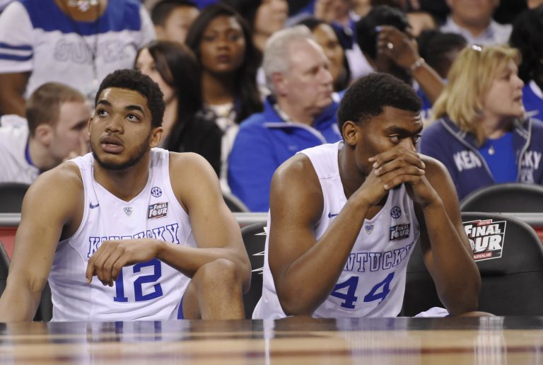Kentucky Wildcats forward Karl-Anthony Towns (12) and Dakari Johnson (44) sit on the bench following their loss to the Wisconsin Badgers 71-64 in the 2015 NCAA Men's Division I Championship