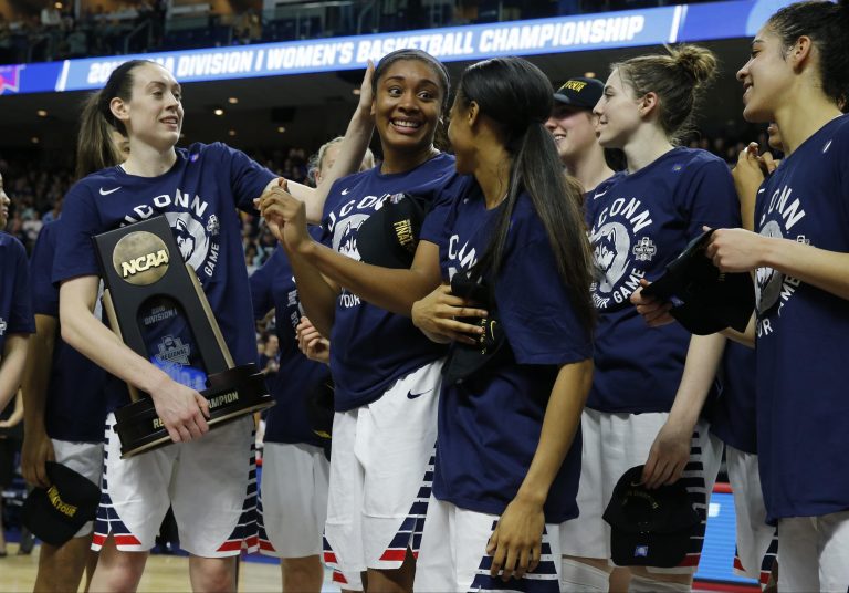 Connecticut Huskies forward Morgan Tuck (3), forward Breanna Stewart (30) and guard Moriah Jefferson (4) celebrate with their teammates after defeating the Texas Longhorns in the finals of the Bridgeport regional of the women's NCAA Tournament at Webster Bank Arena. UConn defeated Texas 86-65.