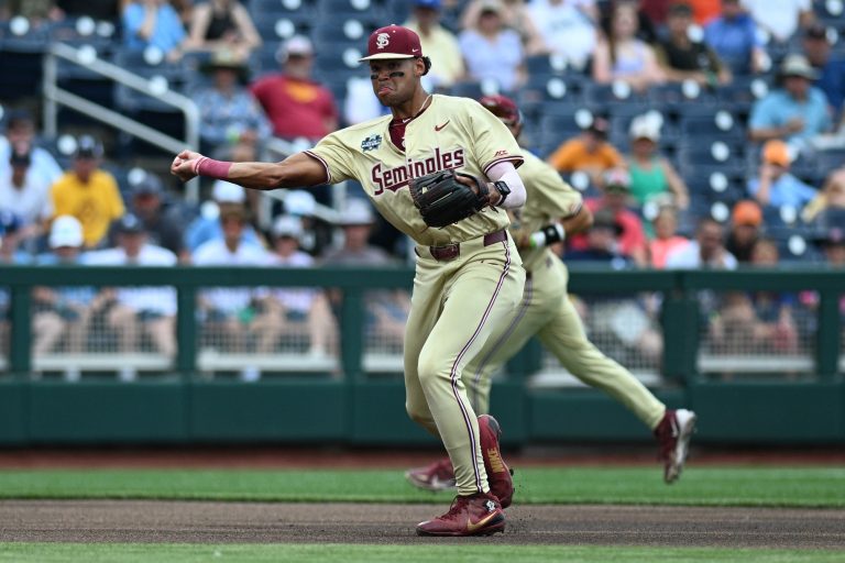 Florida State Seminoles third baseman Cam Smith (24) throws to first base against the North Carolina Tar Heels during the first inning at Charles Schwab Field Omaha.