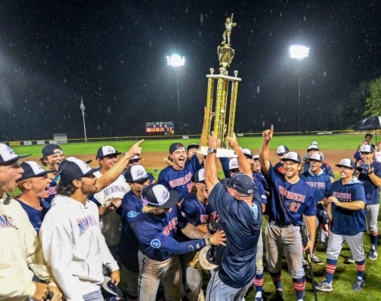 BOURNE 08/12/24 Harwich field manager Steve Englert brings the Arnold Mycock trophy to his team after defeating Bourne for the Cape League championship.